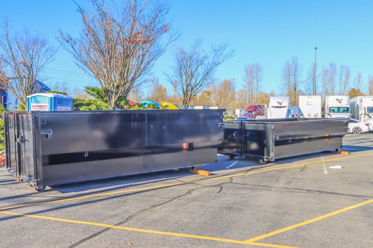 Professional dumpster rental service with roll-off container on residential driveway in Springfield